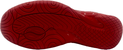 Red athletic sneakers with textured sole and white lightning bolt design, displayed on white background.